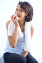 Your diet is more than half the work. A healthy young beauty enjoying a crunchy apple after a workout. Royalty Free Stock Photo