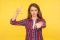 Your failure! Portrait of ginger girl in shirt showing loser gesture, L finger sign and pointing at camera, smiling sarcastic Royalty Free Stock Photo