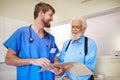 Your file shows great progress. a young doctor and his senior patient discussing his medical records together. Royalty Free Stock Photo