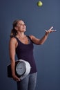 Your health is in your hands. Studio shot of an attractive mature woman throwing an apple and holding a weightscale Royalty Free Stock Photo