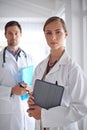 Your medical team. Portrait of two young doctors standing in a hospital corridor. Royalty Free Stock Photo