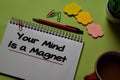 Your Mind Is a Magnet write on a book isolated on office desk