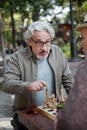 Thoughtful two senior pensioners entertaining with chessboard Royalty Free Stock Photo