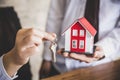 Your new house, real estate agent holding house key to his client after signing contract agreement in office,concept for real Royalty Free Stock Photo