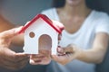 Your new house, woman hands holding a model house. Mortgage property insurance dream moving home and real estate concept Royalty Free Stock Photo