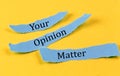 YOUR OPINION MATTER text on a blue pieces of paper on yellow background, business concept
