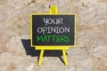 Your opinion matters symbol. Concept words Your opinion matters on beautiful black yellow blackboard. Beautiful stone background. Royalty Free Stock Photo
