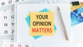 Your opinion matters, the text is written on yellow paper lying on a white notepad on the desktop of an office employee, concept Royalty Free Stock Photo