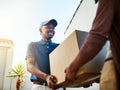 Your package has arrived. a young postal worker delivering a package to a female customer.