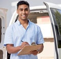 Your package is on my list. Portrait of a young delivery man writing on a clipboard while loading boxes from a van. Royalty Free Stock Photo