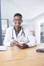 Your results just came in. a handsome young doctor sitting alone in his office at the clinic and using his digital Royalty Free Stock Photo