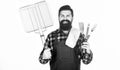 Your satisfaction guaranteed with cooking tool set. Happy hipster holding stainless steel tools. Bearded man with Royalty Free Stock Photo