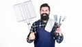 Your satisfaction guaranteed with cooking tool set. Happy hipster holding stainless steel tools. Bearded man with Royalty Free Stock Photo