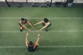 Is your solo exercise routine getting a little humdrum. a fitness group doing squats while working out at the gym.