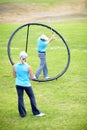 Your swing should stop when you get to here...Image of a male coach instructing his female student using a ring to