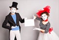 Your text here. Actors mimes holding empty blank board. Colorful studio portrait with gray background. April fools day Royalty Free Stock Photo