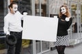 Your text here. Actors mimes holding empty white letter. Colorful portrait with gray background. April fools day Royalty Free Stock Photo