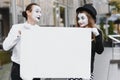 Your text here. Actors mimes holding empty white letter. Colorful portrait with gray background. April fools day Royalty Free Stock Photo