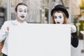 Your text here. Actors mimes holding empty white letter. Colorful portrait with gray background. April fools day Royalty Free Stock Photo