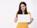 Your text here. Pretty young woman holding empty blank board. Studio portrait on white background. Mockup for design Royalty Free Stock Photo