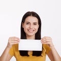 Your text here. Pretty young woman holding empty blank board. Studio portrait on white background. Mockup for design Royalty Free Stock Photo