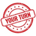 YOUR TURN text on red grungy round rubber stamp