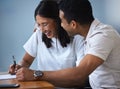 Your velvet touch sends me back to the moon. a young couple completing paperwork at an office.