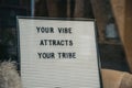 Your vibe attracts your tribe motivational quote on a board Royalty Free Stock Photo