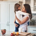 Youre the apple of my eye. a happy mother hugging her cute little girl in the kitchen at home. Royalty Free Stock Photo