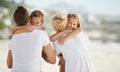 Youre the best parents ever. A happy young family embracing while on the beach.