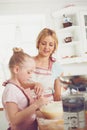 Youre doing a great job. Cute little girl baking in the kitchen with her mom.