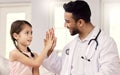 Youre doing so much better than last time. a male doctor visiting a little girl at home.