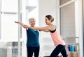 Youre doing so well. a fitness instructor helping a senior woman during a yoga class.