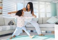 Youre doing so well. a young mother and daughter doing yoga at home.