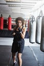 Youre a fighter not a quitter. a female kick-boxer training at the gym. Royalty Free Stock Photo