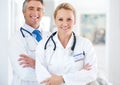 Youre in good hands. Portrait of two doctors standing in a hospital corridor. Royalty Free Stock Photo