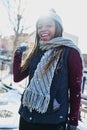 Youre looking at the snowball fighting champ here. a beautiful young woman throwing a snowball on a wintery day outdoors