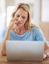 Youre never alone nowadays. a mature woman using a laptop at home.