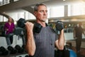 Youre never too old to lift. a senior man working out with weights at the gym.
