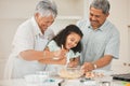 Youre our favourite grandchild. grandparents helping their grandchild stir a bowl of muffin batter.