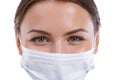 Youre in safe hands. A closeup image of a beautiful surgeon wearing a surgical mask.