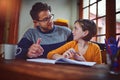 Youre such an expert, Dad. a father helping his little daughter with her homework.