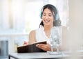 Youre welcome to call in with your questions too. a young woman writing notes during a broadcast in an office. Royalty Free Stock Photo