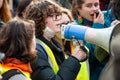 Youth activist with megaphone at the Climate Change demonstration in London.