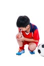 Youth asian soccer player with pain in knee joint. Full body.