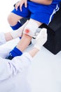 Youth asian sport boy in blue uniform. Knee joint pain.