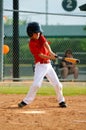 Youth baseball player swinging bat