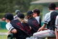 Baseball team standing in dugout