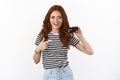 Youth, finance and banking concept. Cheerful ambitious cute redhead female student in striped t-shirt introduce black