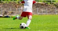 Youth Football Soccer Player Hits a Ball. Footballer Kicking Ball Royalty Free Stock Photo